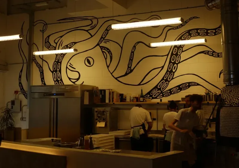 The open kitchen and octopus mural